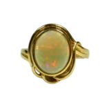 A 14CT YELLOW GOLD AND CABOCHON OPAL RING Having bezel set oval opal, pierced gallery. (approx