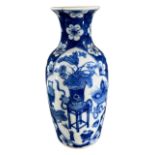 A CHINESE BLUE AND WHITE ROULEAU VASE Decorated with two shaped cartouches enclosing antiques and