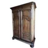A LARGE 18TH CENTURY FRENCH OAK ARMOIRE Wth shaped panelled doors opening to reveal shelf interior