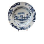 AN 18TH CENTURY BLUE AND WHITE ENGLISH DELFT CHINOISERIE PLATE Painted with a woman beside a