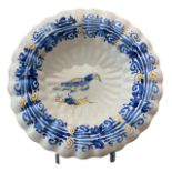 A 17TH CENTURY DUTCH DELFTWARE LOBED PLATE Painted in blue, green and yellow the centre decorated
