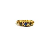 SAMUEL USHER LTD, A LATE EDWARDIAN 18CT GOLD, DIAMOND AND BLUE TOPAZ FIVE STONE RING Having