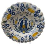 A LATE 17TH CENTURY DUTCH DELFTWARE LOBED CHARGER Painted in blue, green and yellow with a bust-