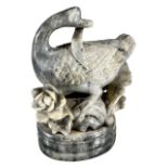 A LARGE CHINESE SOAPSTONE CARVING OF A GOOSE Raised on a rockery floral base. (h 19.5cm x w 15cm x d