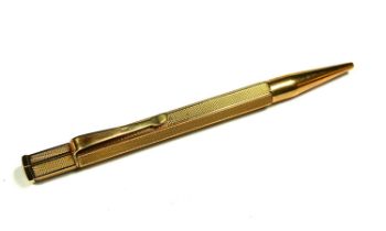 COHEN & CHARLES, A 9CT GOLD ENGINE TURNED PENCIL, HALLMARKED BIRMINGHAM, 1966. (length 11cm, gross