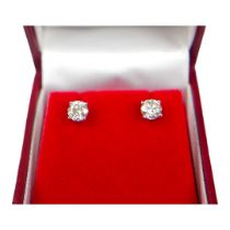 A PAIR 18CT WHITE GOLD FOUR CLAW ROUND BRILLIANT CUT DIAMOND STUDS, boxed. (Approx diamonds 1.15ct.)