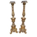 A PAIR OF 18TH/19TH CENTURY FRENCH CARVED GILTWOOD PRICKET STANDS Decorated with foliage and