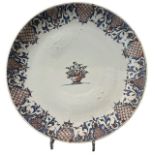 AN 18TH CENTURY DELFTWARE TIN GLAZE CHARGER Decorated with central floral basket vase, white ground,