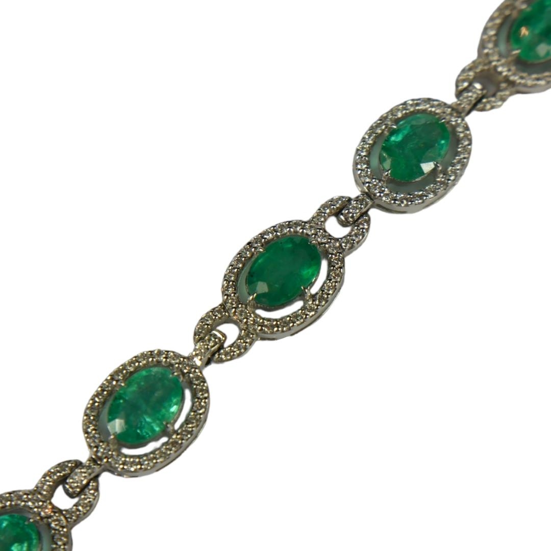 AN 18CT WHITE GOLD, EMERALD AND DIAMOND LINE BRACELET. (Approx. Oval emeralds 7.12ct total. Diamonds - Image 2 of 4