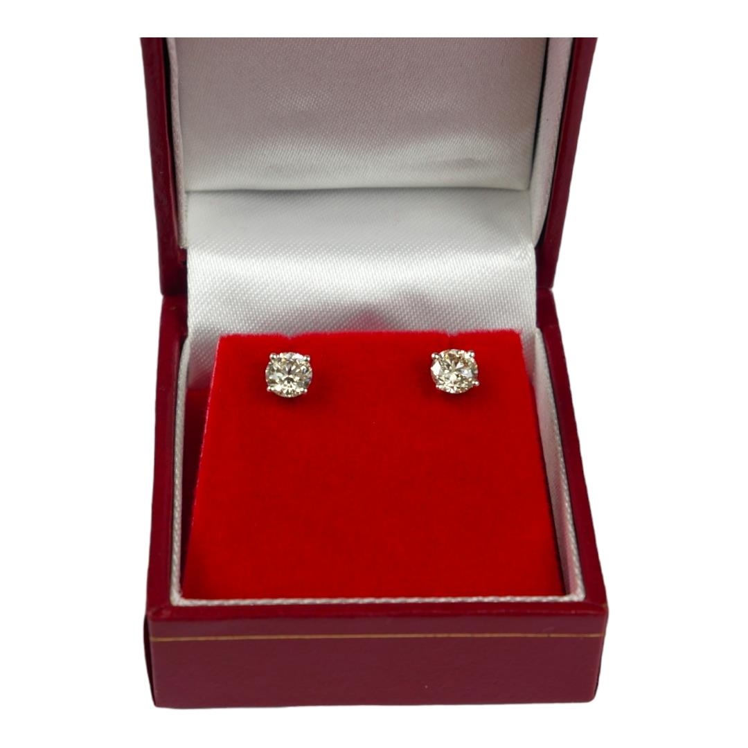 A PAIR 18CT WHITE GOLD FOUR CLAW ROUND BRILLIANT CUT DIAMOND STUDS, boxed. (Approx diamonds 1.15ct.) - Image 2 of 3