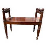 IN THE MANNER OF GEORGE BULLOCK, AN EARLY 19TH CENTURY REGENCY CARVED MAHOGANY WINDOW SEAT/BENCH