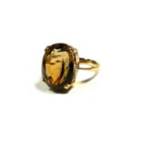 A LARGE 9CT GOLD AND OVAL CUT CITRINE COCKTAIL RING. (citrine approx dimensions 18mm x 15mm, UK ring