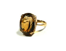 A LARGE 9CT GOLD AND OVAL CUT CITRINE COCKTAIL RING. (citrine approx dimensions 18mm x 15mm, UK ring