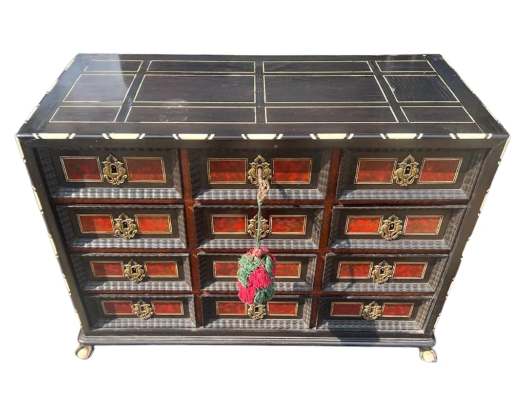 A 17TH CENTURY FLEMISH TORTOISESHELL EBONY AND BONE INLAID TABLE CABINET Having an arrangement of