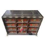 A 17TH CENTURY FLEMISH TORTOISESHELL EBONY AND BONE INLAID TABLE CABINET Having an arrangement of