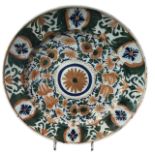 AN 18TH CENTURY DELFTWARE TIN GLAZE CHARGER Decorated in green, orange and blue, central floral