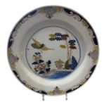 A MID 18TH CENTURY ENGLISH DELFTWARE CHARGER Painted with a polychrome design of a bird in flight
