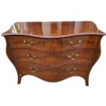 MANNER OF HENRY HILL OF MARLBOROUGH, A GEORGE III FLAME MAHOGANY SERPENTINE COMMODE CHEST Of three