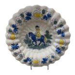 A LATE 17TH CENTURY DUTCH DELFTWARE LOBED CHARGER PLATE Blue, green and yellow with central