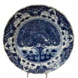 AN 18TH CENTURY DUTCH DELFT CHINOISERIE DISH Decorated in blue with flower vases on a terrace