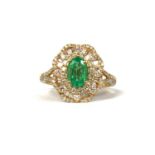 A 14CT YELLOW GOLD CLUSTER RING, with central oval emerald surrounded by baguette cut diamonds and