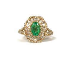 A 14CT YELLOW GOLD CLUSTER RING, with central oval emerald surrounded by baguette cut diamonds and