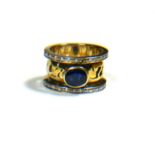 A LARGE YELLOW METAL, SAPPHIRE AND DIAMOND RING, YELLOW METAL TESTED AS 18CT GOLD Having pierced