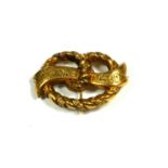 A LATE VICTORIAN YELLOW METAL ROPE BOW BROOCH, YELLOW METAL TESTED AS 18CT GOLD Having chased and