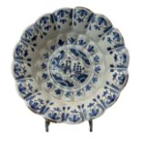 A 17TH CENTURY DELFTWARE CENTRAL LOBED DISH Landscape scene, encircled by multiple geometrical