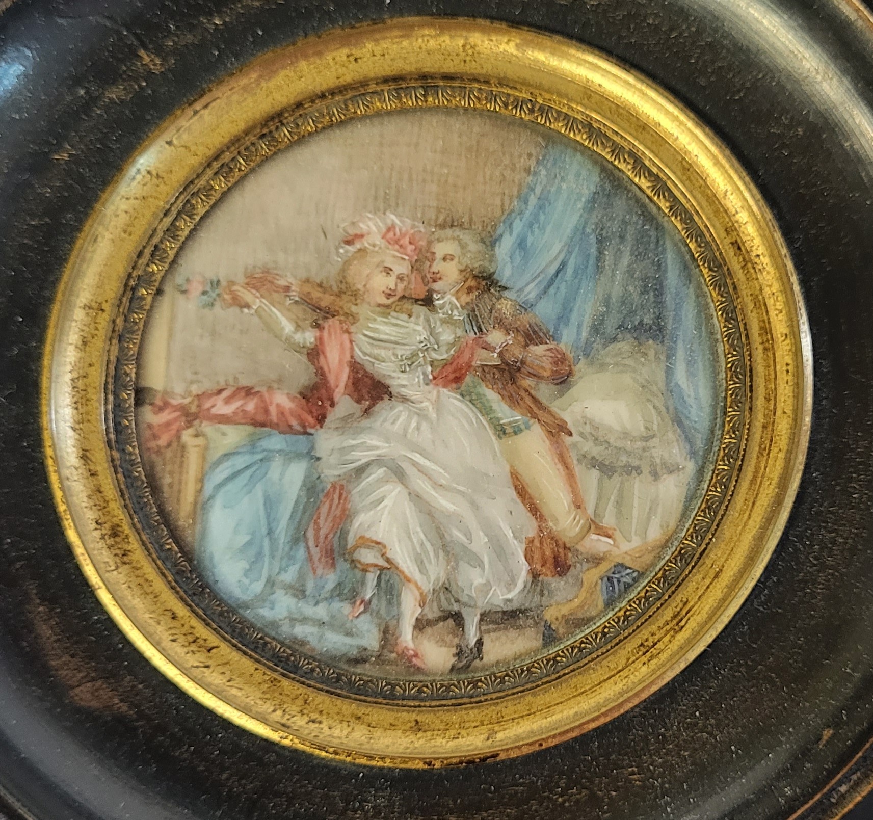 A 19TH CENTURY CIRCULAR MINIATURE PAINTING ON IVORY, BEDROOM SCENE WITH COURTING COUPLE In an - Image 2 of 3