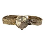 OMEGA, A VINTAGE 9CT GOLD LADIES’ WRISTWATCH The circular silver tone dial with herringbone design