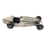 A VINTAGE WHITE METAL MODEL BUGATTI RACING CAR,marked to base Bugatti HP230 1933. Approx 9cm.