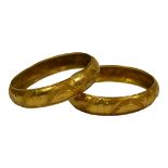 A PAIR OF CONTINENTAL 21CT GOLD BANGLES Embossed decoration of semicircles and fans, marked ‘
