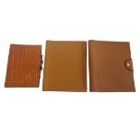 HERMÈS, A COLLECTION OF THREE LEATHER NOTEPAD COVERS To include crocodile skin cover with pen. (