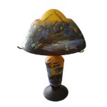 A GALLE STYLE GLASS MUSHROOM TABLE LAMP, with dragonfly and floral shade and base on a yellow