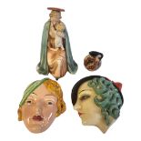 AN ART DECO BESWICK POTTERY WALL MASK FORMED AS A GIRLS HEAD IN A GREEN HAT, CIRCA 1935 Impressed