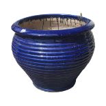 A BLUE GLAZED STONEWARE GARDEN PLANTER With ribbed body. (65cm x 55cm) Condition: good throughout