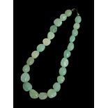 A 20TH CENTURY JADEITE NECKLACE Set with various light green lustre jadiete stones. (length 45cm)