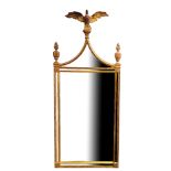 AN 18TH CENTURY STYLE GILT FRAMED MIRROR With eagle crest and torches above sectional silvered