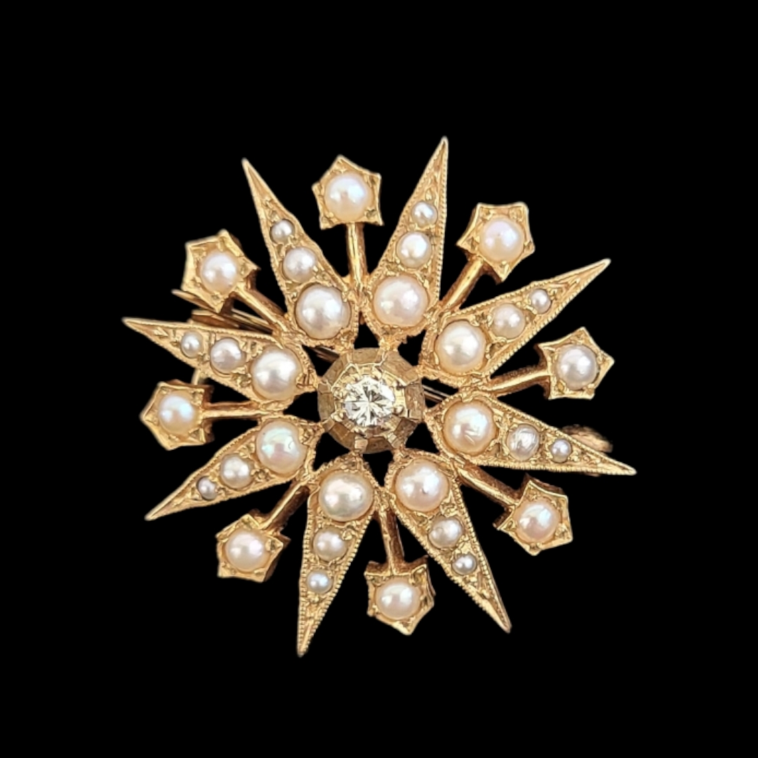 AN EARLY 20TH CENTURY 9CT GOLD, DIAMOND AND SEED PEARL STAR BROOCH Having a single round cut diamond