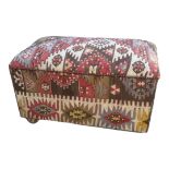 A KILIM COVERED OTTOMAN. (93cm x 52cm x 54cm)