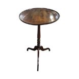 A GEORGIAN SOLID WALNUT OCCASIONAL TABLE with circular tilt, top raised on a turned column, standing