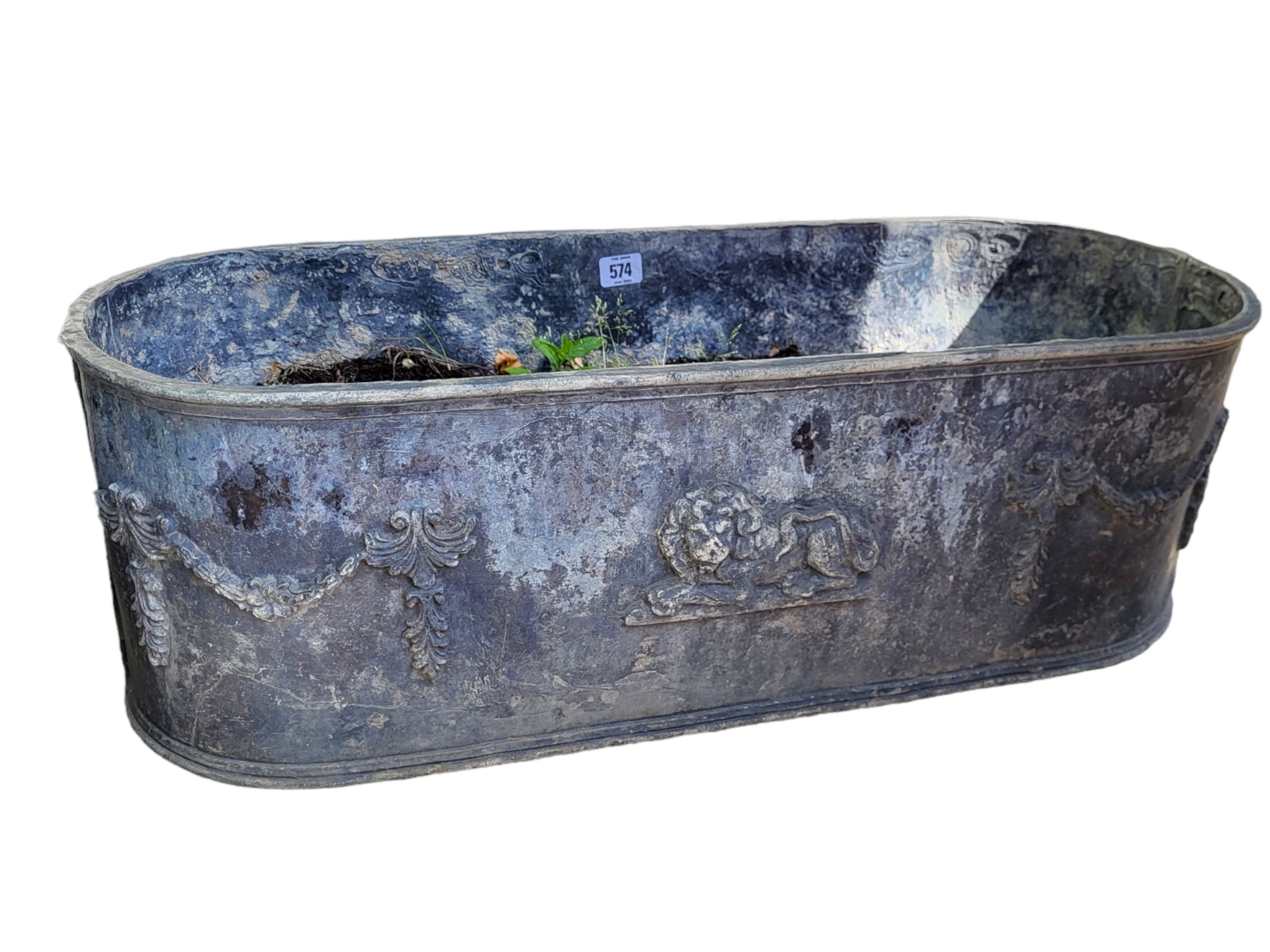 AN 18TH CENTURY DESIGN LEAD GARDEN OVAL PLANTER Figured with a recumbent lion and Adams swags. (75cm