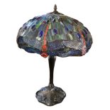 A TIFFANY STYLE GLASS TABLE LAMP, with dragonfly glass shade on a blue ground, bronzed base.