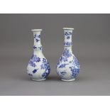 A Pair of Fluted Blue and White Vases, Kangxi, of pear shape, with tall knopped necks rising to a