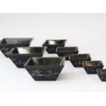 A Rare Nesting Set of Eight 'lac burgaute' Cups, Kangxi, the black lacquered cups of square section,