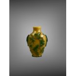 A green overlay amber glass Snuff Bottle, 19th century, of shield form carved with tree shrews and