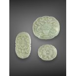 A Fine group of Three celadon jade Plaques, 19th century, probably from a ruyi sceptre, very well