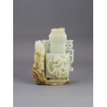A celadon Jade Dragon and Vase Group, the vase and cover of square section, standing on rockwork,