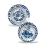 A CHINESE KANGXI BLUE AND WITH PLATE, decorated with vases of flowers, along with a large charger of